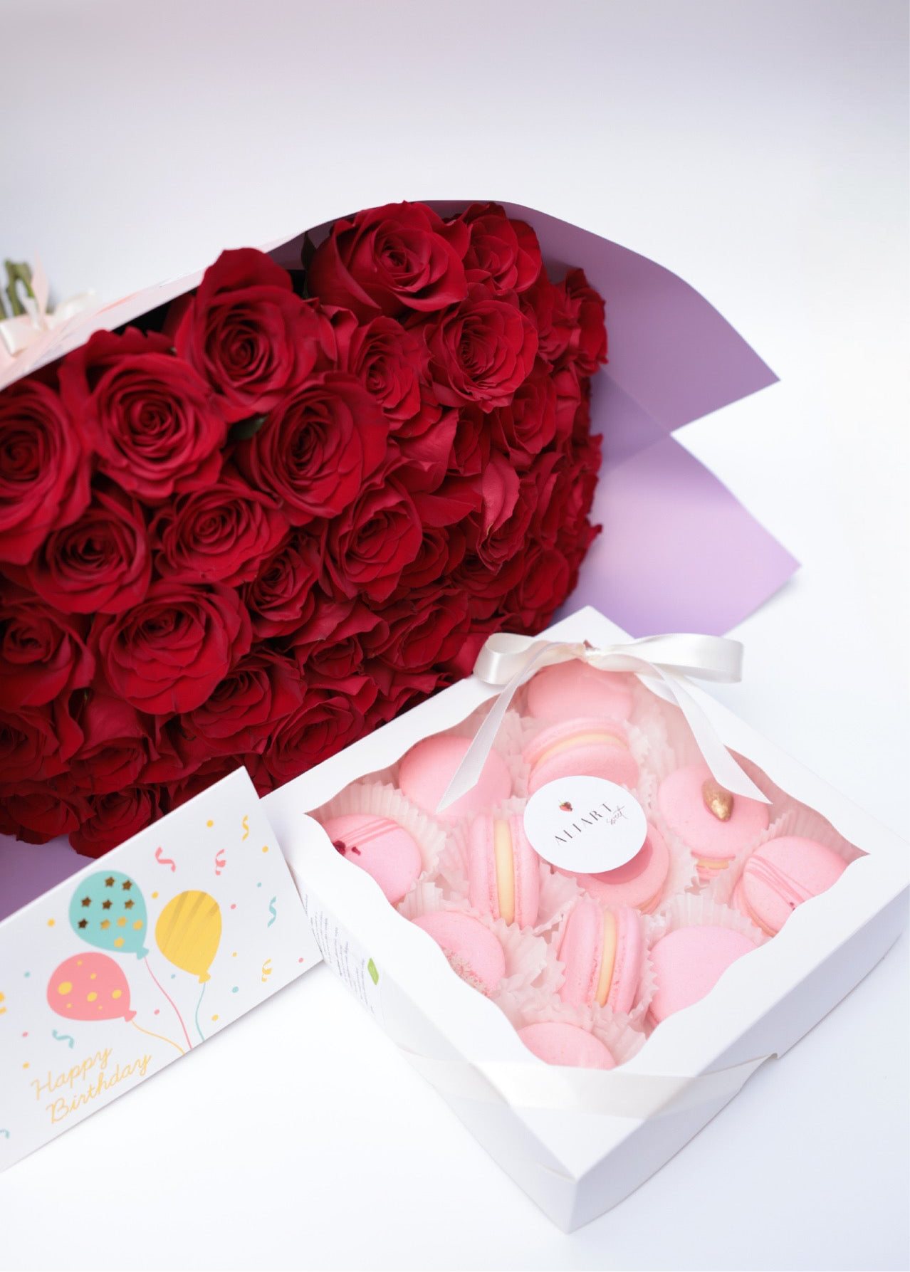 Surprise someone special with our elegant set featuring a bouquet of fresh roses, a selection of delicate macarons, and a personalized greeting card. The vibrant roses add a touch of natural beauty and fragrance, while the assorted macarons offer a delightful array of flavors and colors. This thoughtfully arranged set, complete with a heartfelt greeting card, is perfect for any occasion, expressing your sentiments with style and sweetness.