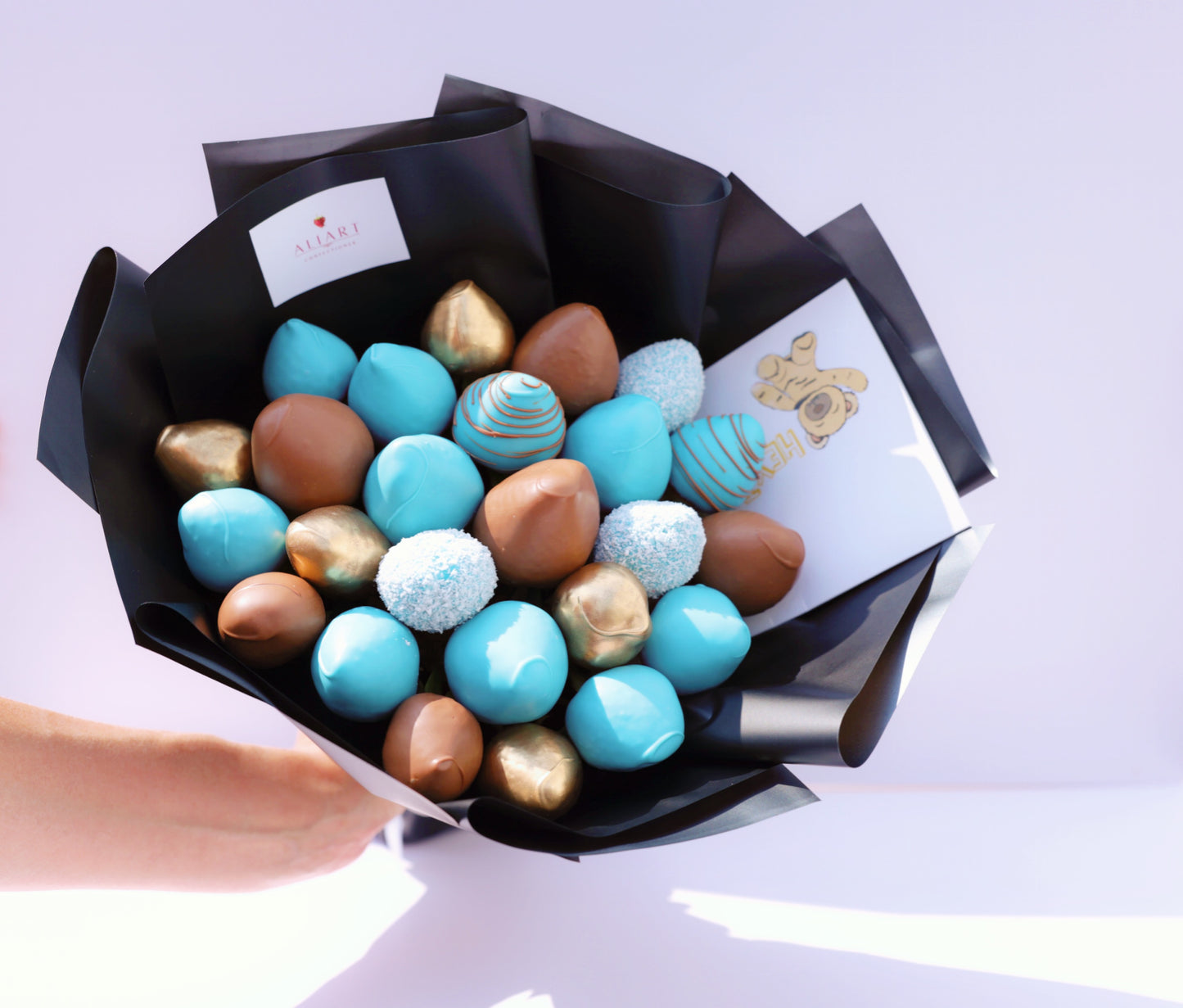 A stunning bouquet of luscious, fresh strawberries, artfully arranged and wrapped in elegant paper. Perfect for gifting or indulging yourself. Treat yourself or a loved one to this sweet and unique delight today!