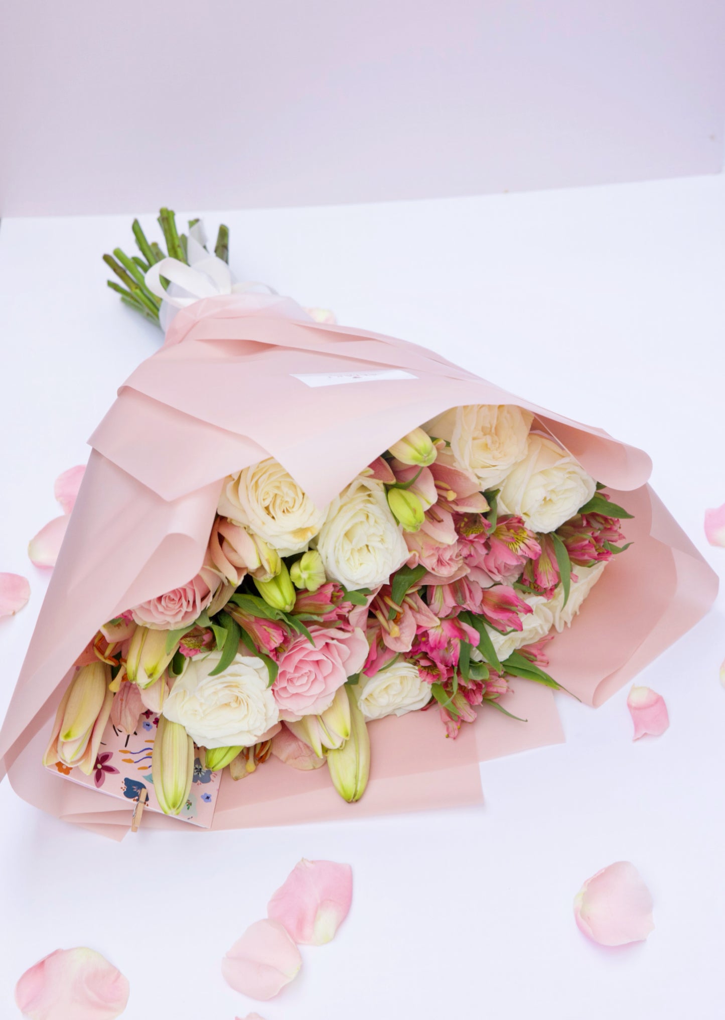 Enchant your loved ones with our Roses and Seasonal Flowers bouquet. This captivating arrangement blends classic roses with the freshest seasonal blooms, creating a vibrant and stunning display. Order now to brighten someone's day with this beautiful bouquet!