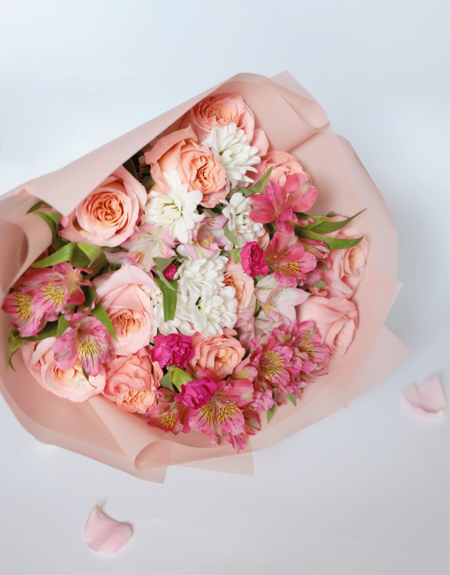 Enchant your loved ones with our Roses and Seasonal Flowers bouquet. This captivating arrangement blends classic roses with the freshest seasonal blooms, creating a vibrant and stunning display. Order now to brighten someone's day with this beautiful bouquet!