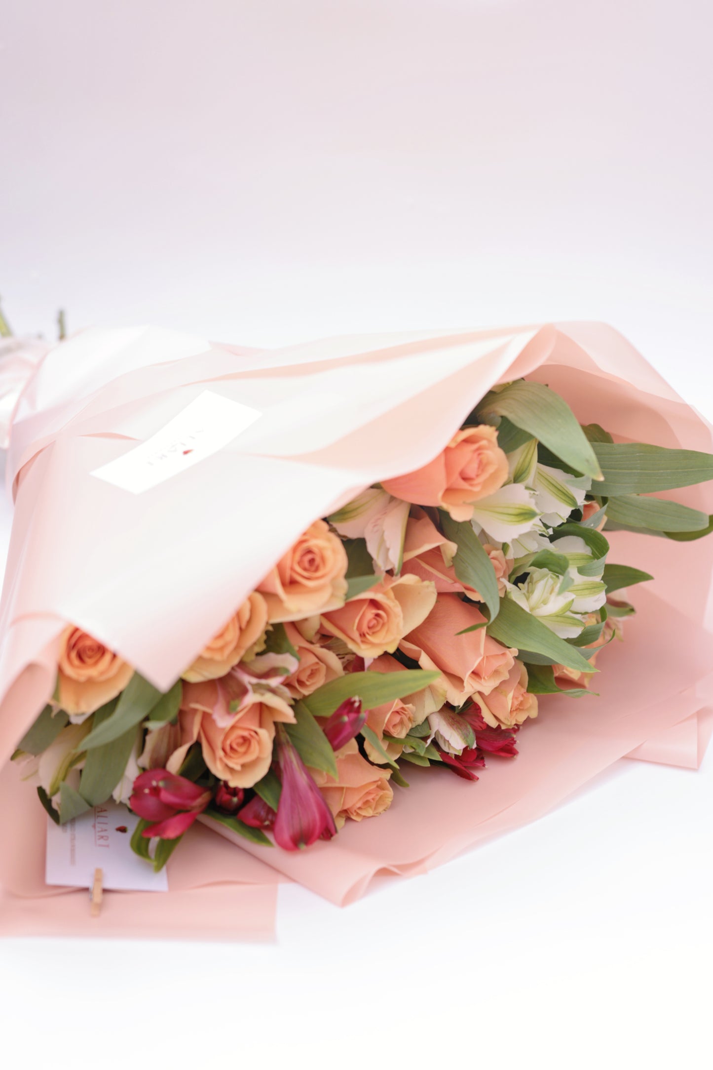 Brighten someone's day with our beautiful bouquet of roses and seasonal flowers, accompanied by a personalized greeting card. This stunning arrangement features fresh, vibrant roses mixed with an assortment of seasonal blooms, creating a perfect blend of colors and fragrances. The bouquet, paired with a heartfelt greeting card, makes for an exquisite gift suitable for any special occasion.
