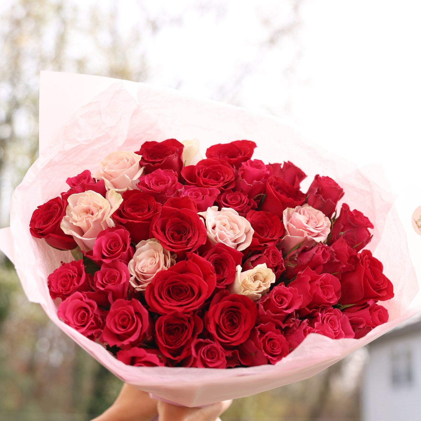 Beautifully arranged roses with lush greenery, a timeless gift for loved ones