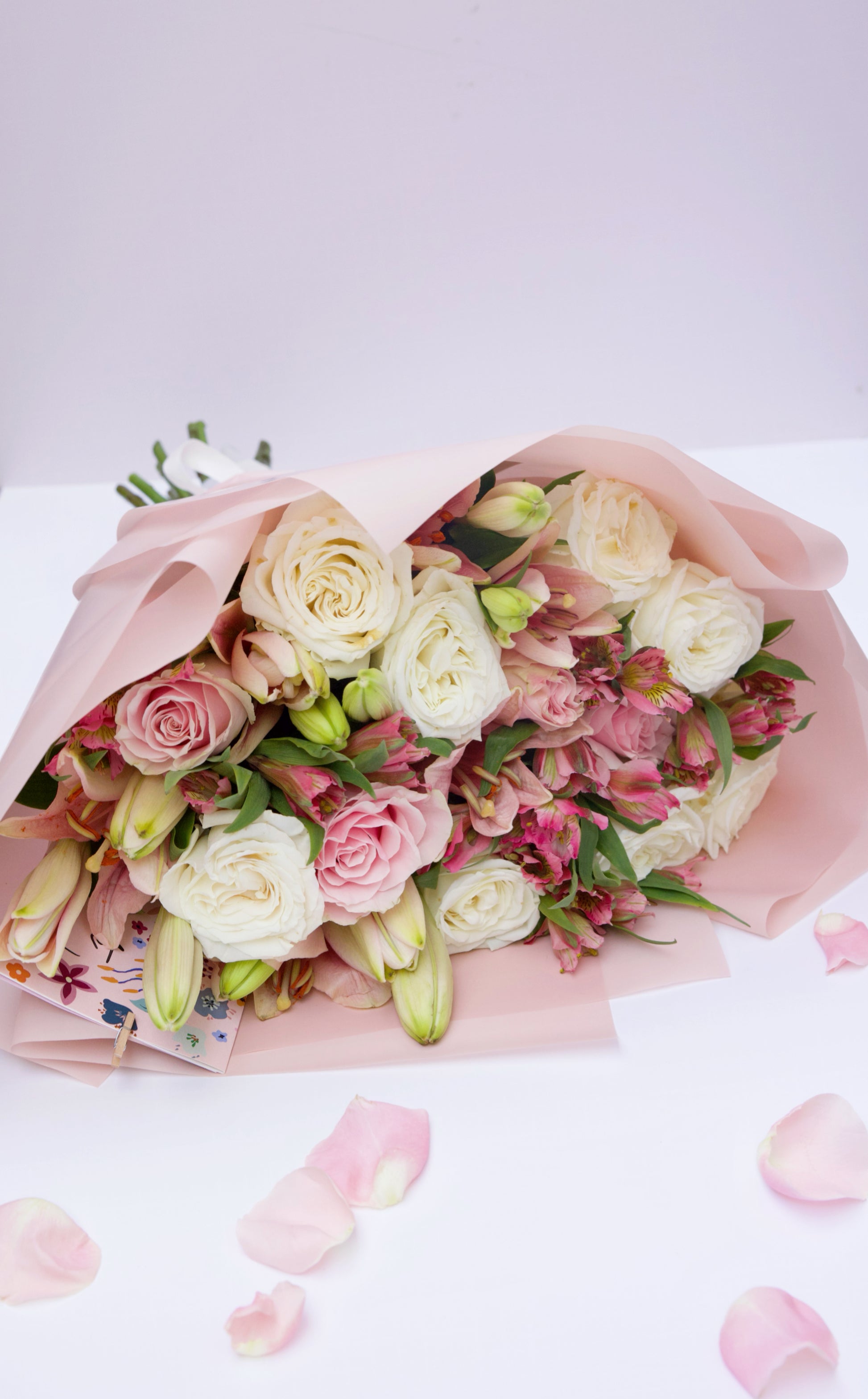 Enchant your loved ones with our Roses and Seasonal Flowers bouquet. This captivating arrangement blends classic roses with the freshest seasonal blooms, creating a vibrant and stunning display. Order now to brighten someone's day with this beautiful bouquet!
