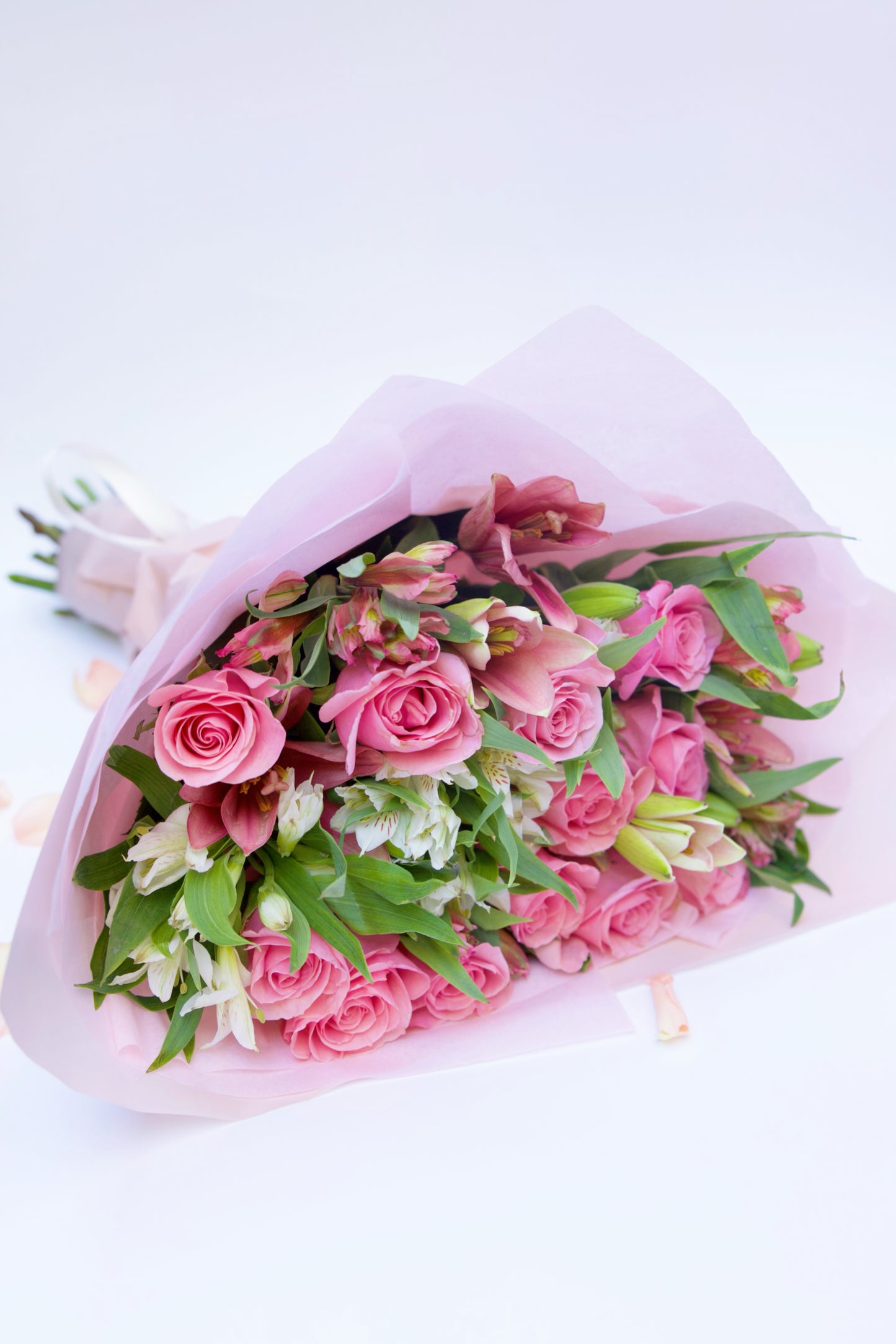 Enchant your loved ones with our Roses and Seasonal Flowers bouquet. This captivating arrangement blends classic roses with the freshest seasonal blooms, creating a vibrant and stunning display. Order now to brighten someone's day with this beautiful bouquet!