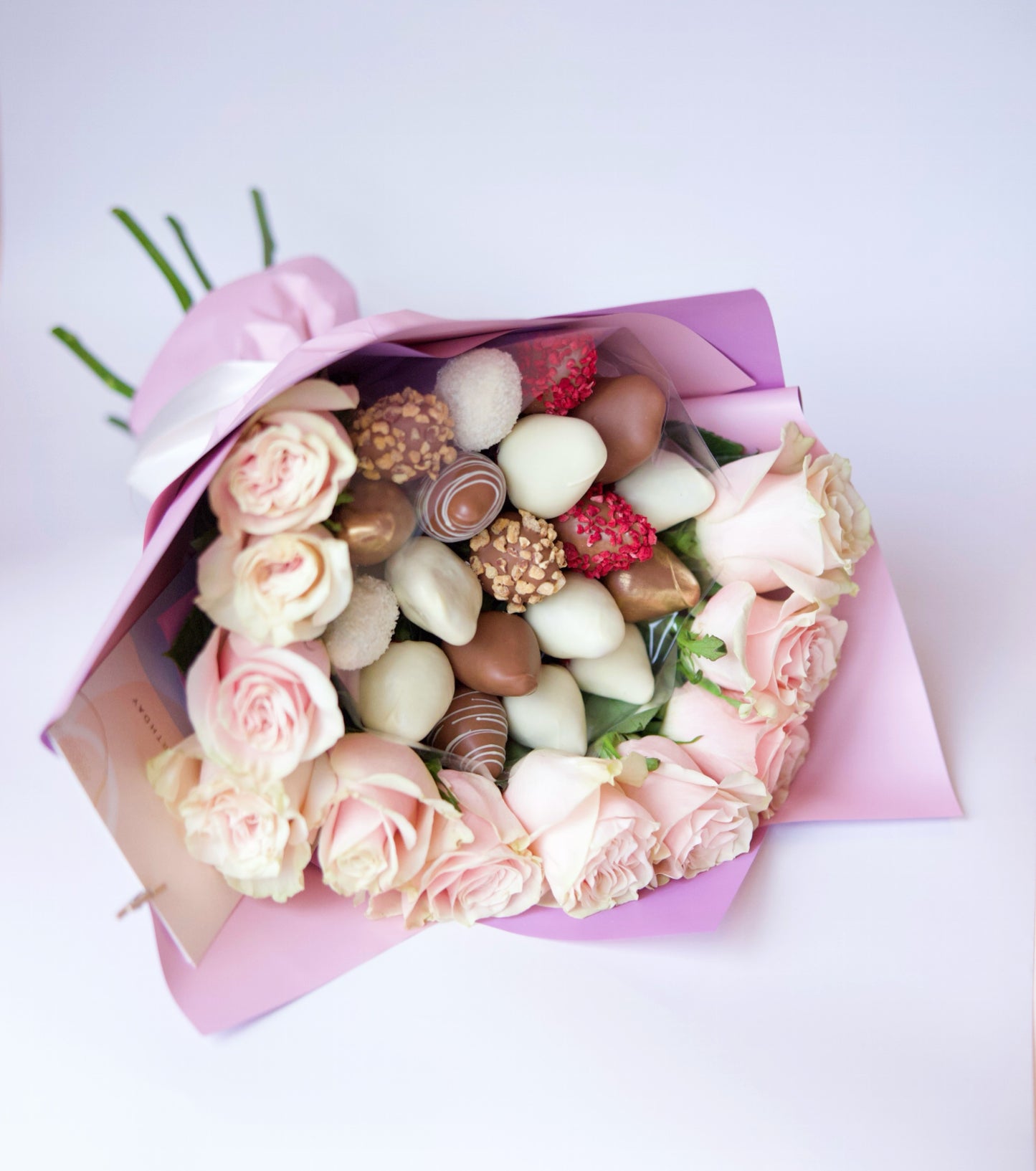 Indulge in the perfect blend of romance and sweetness with our Strawberries and Roses bouquet. This stunning arrangement combines luscious, fresh strawberries with elegant, vibrant roses, creating a unique and memorable gift. Order now to delight your loved one with this exquisite bouquet!