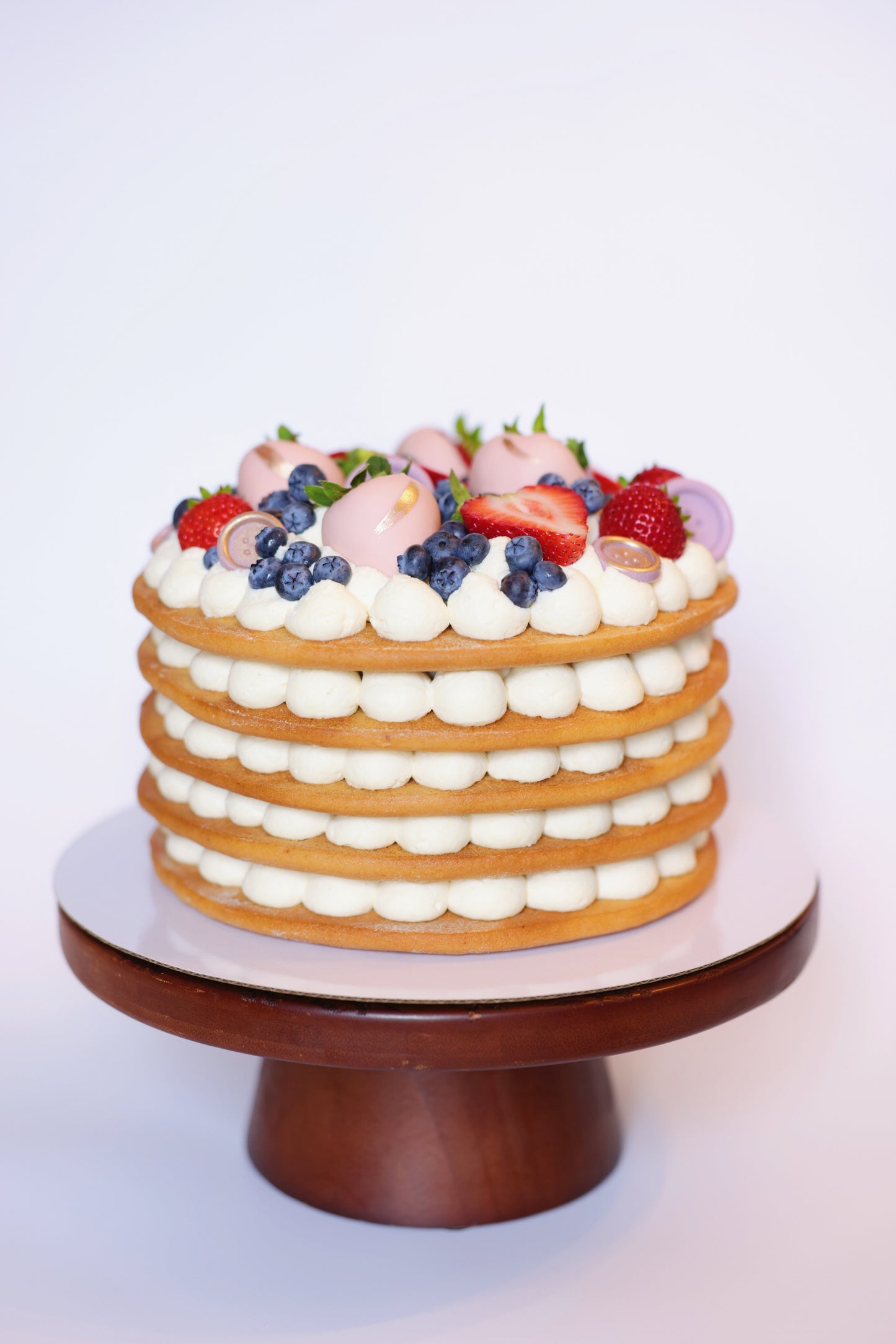 Experience the exquisite taste of our honey cake adorned with a beautiful assortment of fresh berries. This delectable honey cake boasts layers of moist, flavorful sponge, perfectly complemented by the natural sweetness and tartness of ripe strawberries and blueberries. The vibrant berries not only enhance the flavor but also create a stunning visual appeal, making this cake an ideal centerpiece for any celebration.