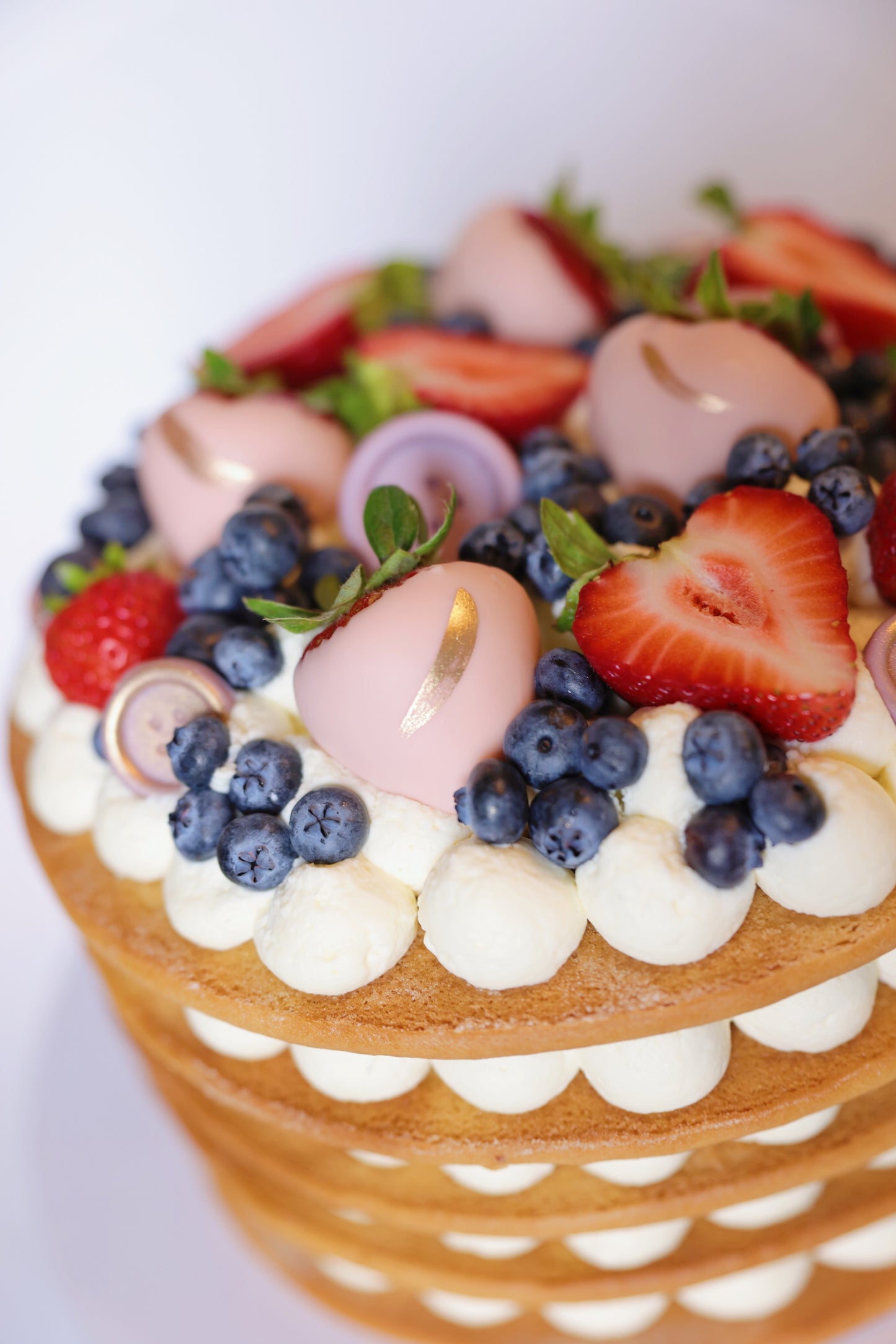 Experience the exquisite taste of our honey cake adorned with a beautiful assortment of fresh berries. This delectable honey cake boasts layers of moist, flavorful sponge, perfectly complemented by the natural sweetness and tartness of ripe strawberries and blueberries. The vibrant berries not only enhance the flavor but also create a stunning visual appeal, making this cake an ideal centerpiece for any celebration.