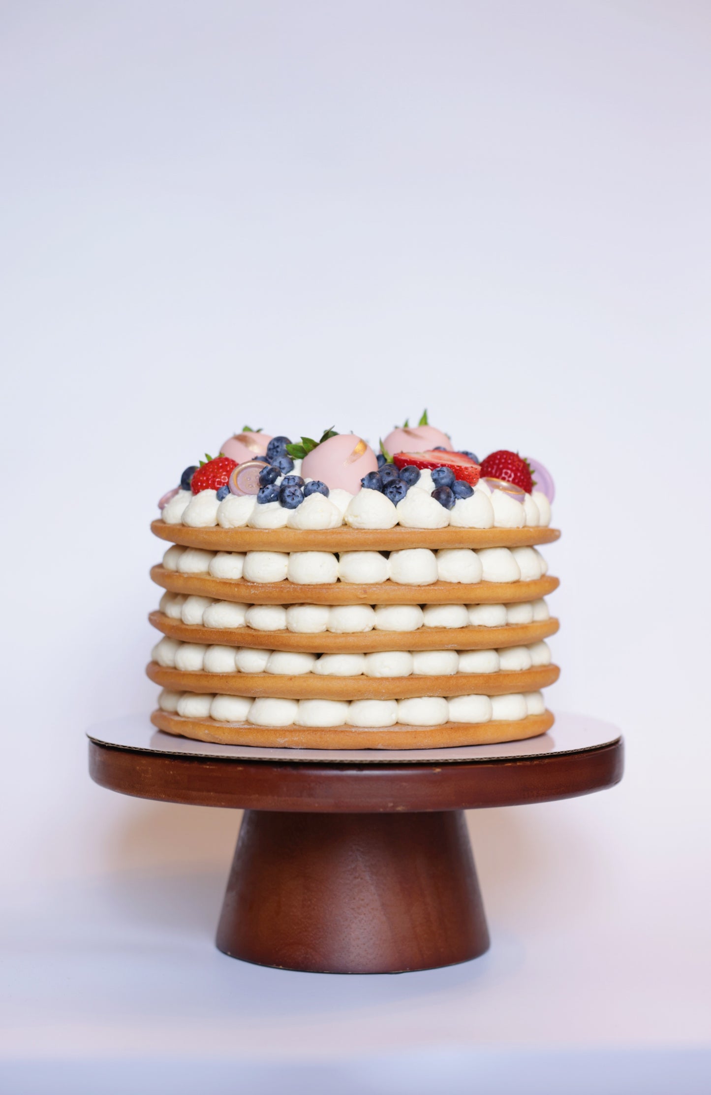 Experience the exquisite taste of our honey cake adorned with a beautiful assortment of fresh berries. This delectable honey cake boasts layers of moist, flavorful sponge, perfectly complemented by the natural sweetness and tartness of ripe strawberries and blueberries. The vibrant berries not only enhance the flavor but also create a stunning visual appeal, making this cake an ideal centerpiece for any celebration.