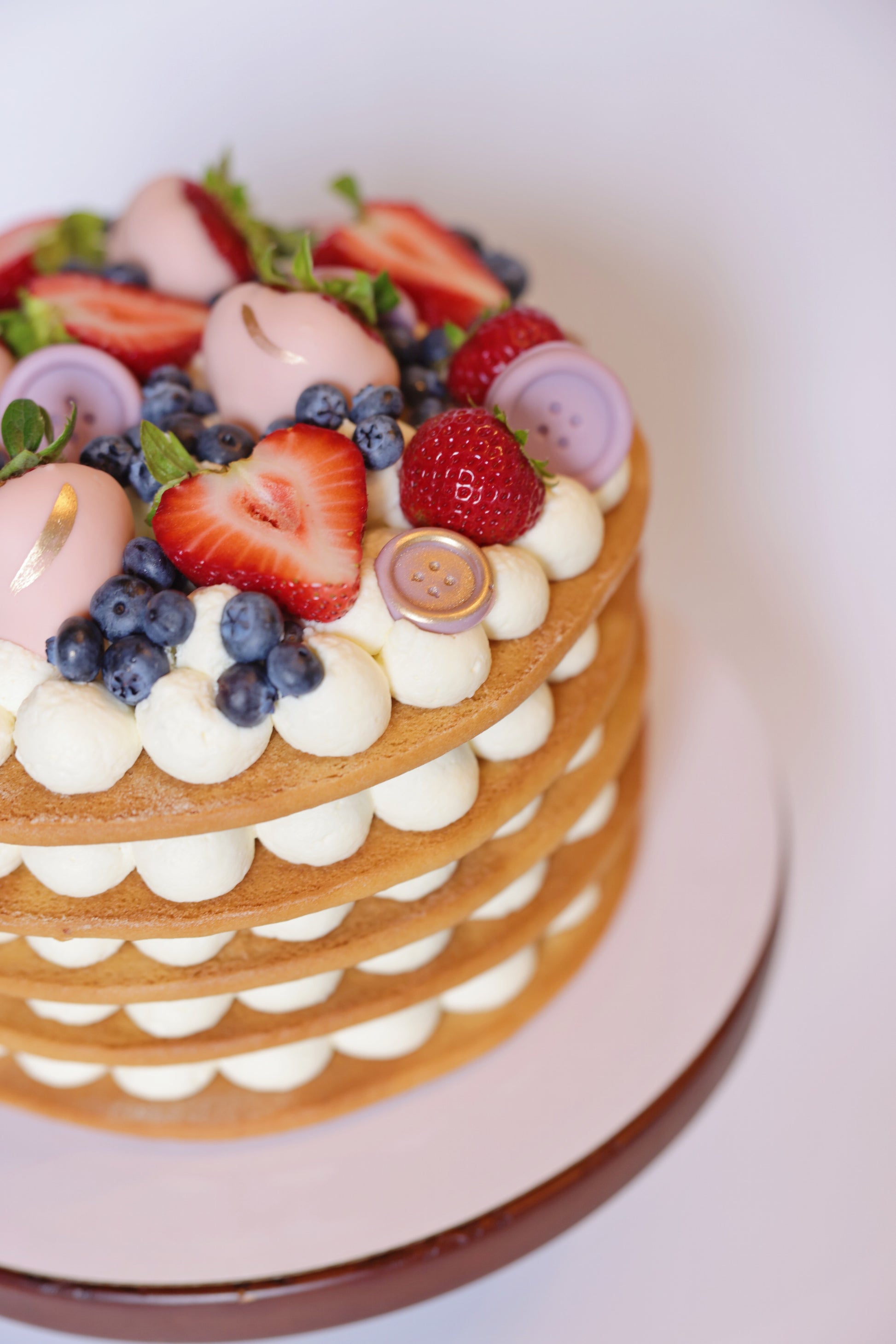 Experience the exquisite taste of our honey cake adorned with a beautiful assortment of fresh berries. This delectable honey cake boasts layers of moist, flavorful sponge, perfectly complemented by the natural sweetness and tartness of ripe strawberries and blueberries. The vibrant berries not only enhance the flavor but also create a stunning visual appeal, making this cake an ideal centerpiece for any celebration.