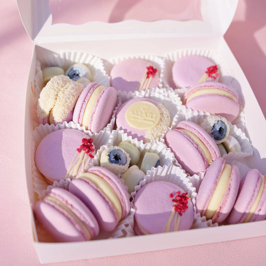 Passion Fruit Macarons with a golden filling, paired with fresh blueberries, arranged beautifully for a delightful dessert presentation.