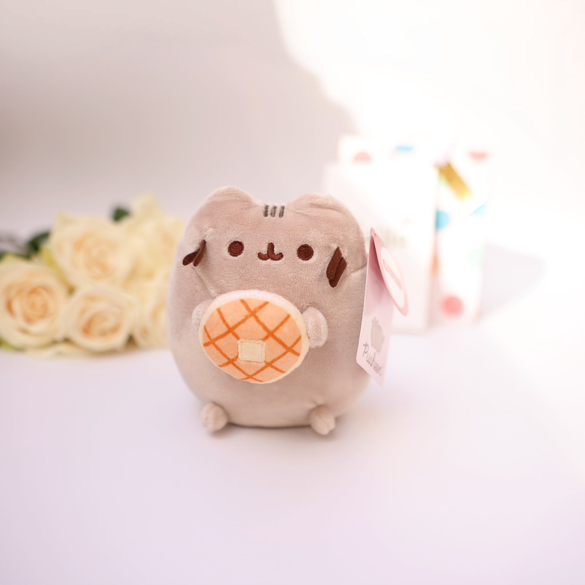 Cute plush cat with a small donut, soft kawaii-style toy.