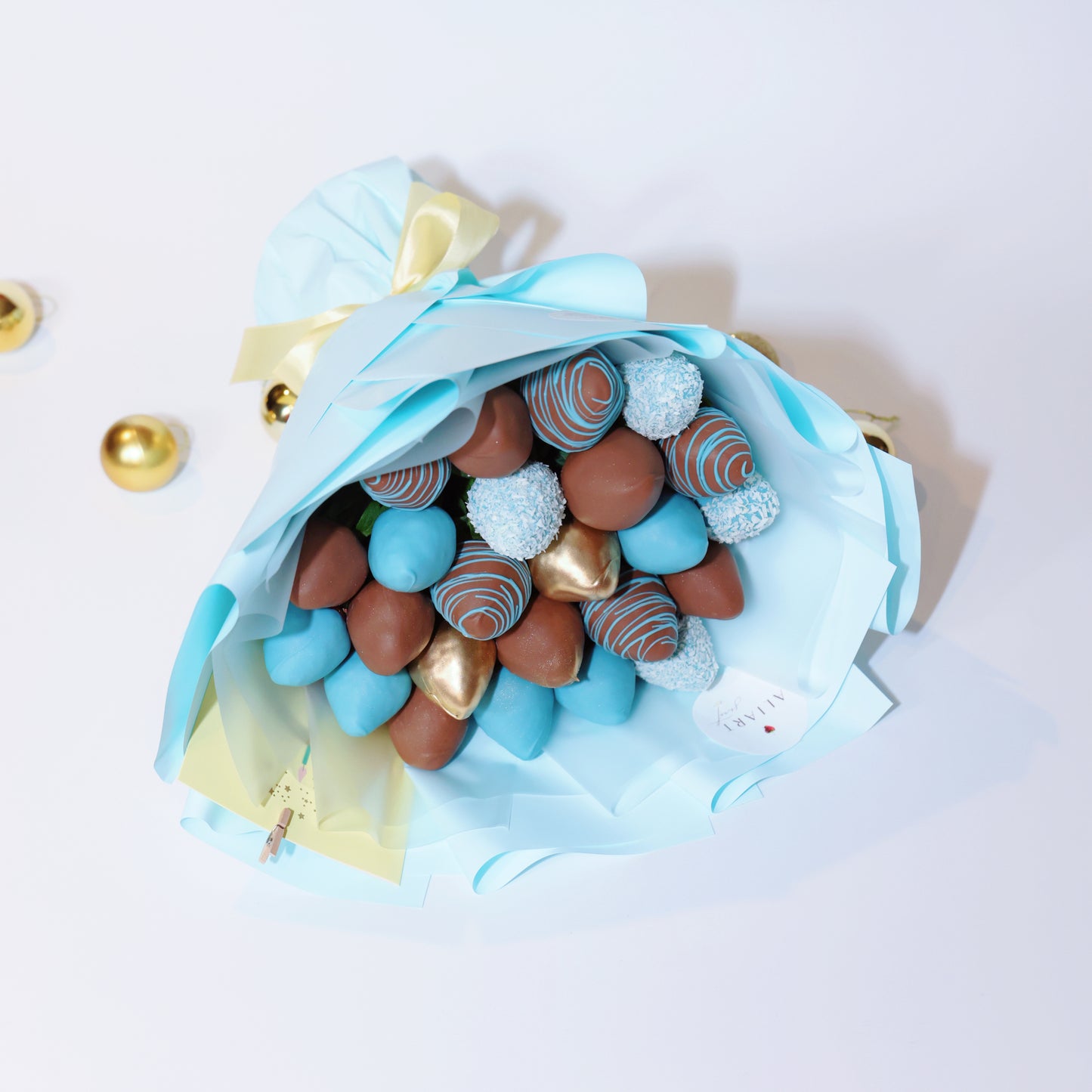 Edible strawberry bouquet with milk and blue chocolate strawberries and gold accents, elegant gift presentation